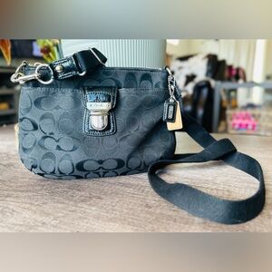 Coach black and silver threading cross body monogram purse.